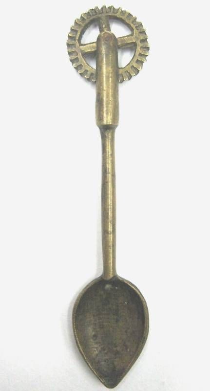 ANTIQUE BRONZE SPOON WITH PASTRY WHEEL