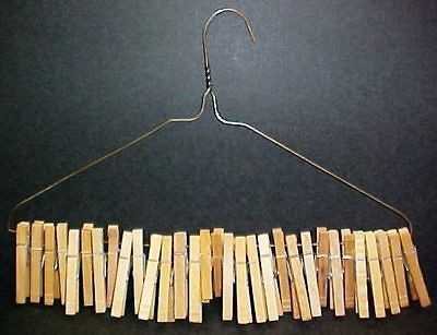 31 vintage wood spring style clothespins on old wire clothes hanger 