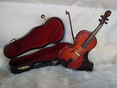   box with black case Bass playing instrument plays tune SWAN LAKE