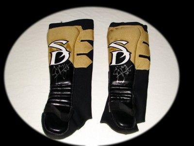 SIGNED SONJAY DUTT TNA RING WORN YELLOW & BLACK KICK PADS. GOOD RING