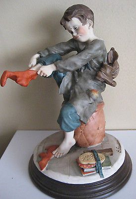 Capodimonte Armani Figurine Scholar Boy Putting On Sock