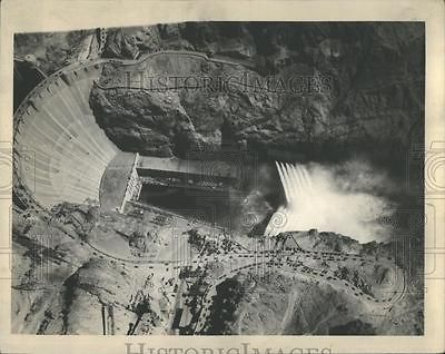 Water whipped to spray cascade from the giant values of Boulder Dam